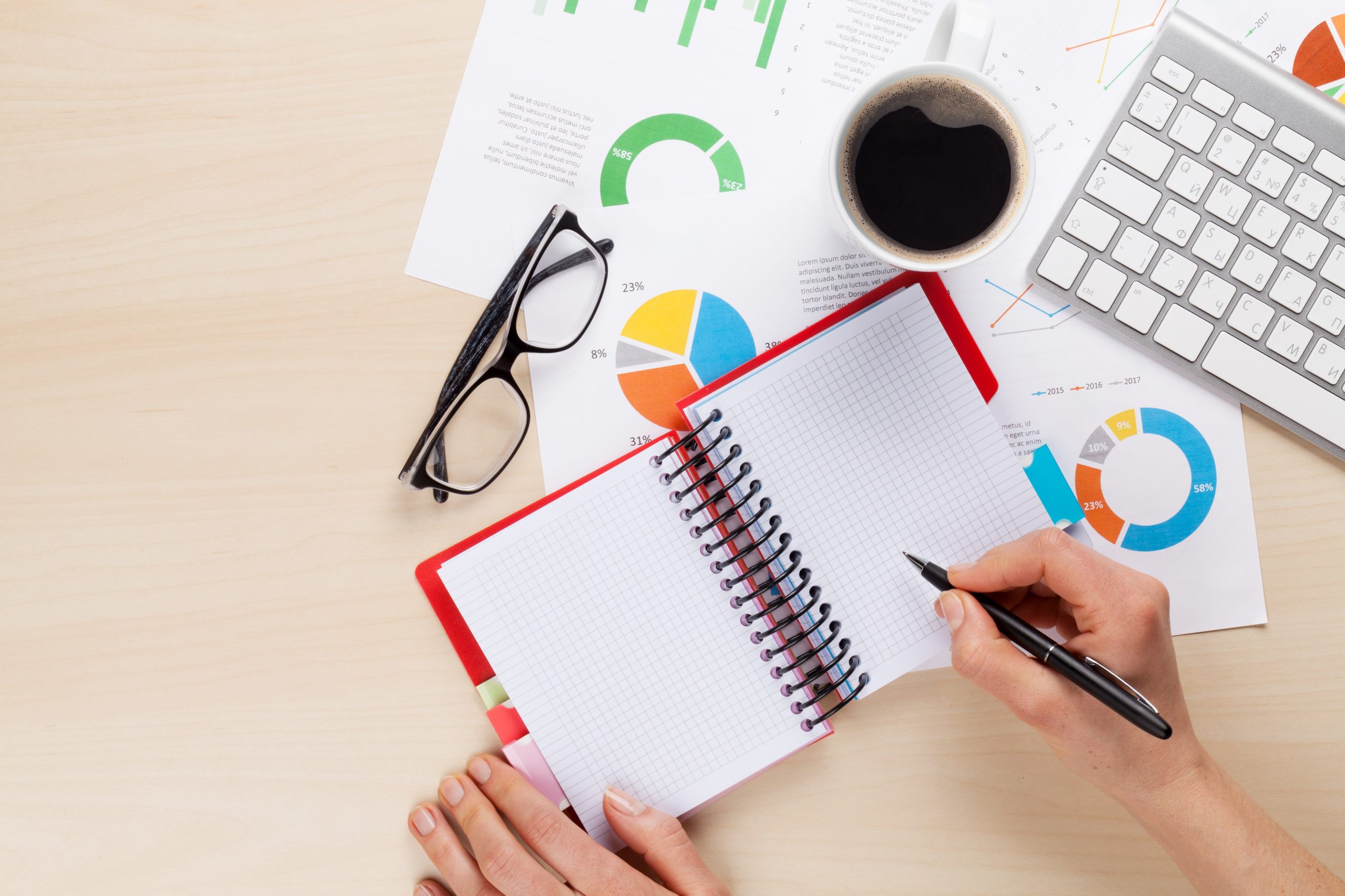 woman-working-with-reports-and-charts-PDREVWQ-min